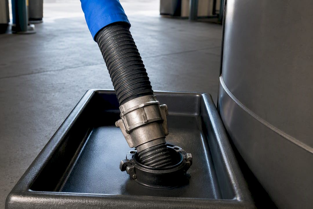 DEF transfer hose connected at receiving port